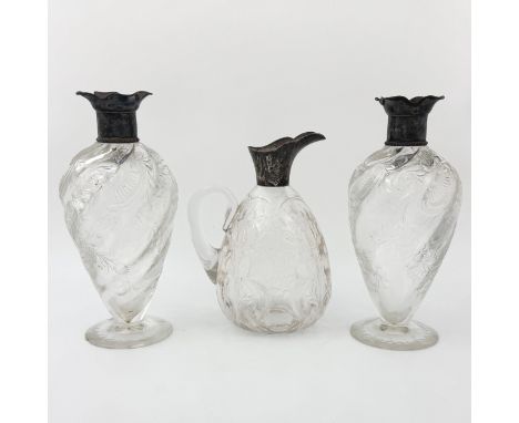 A pair of Edwardian Thomas Webb & Sons 'Rock Crystal' cut glass decanters and a Stevens & Williams 'Rock Crystal' claret jug,