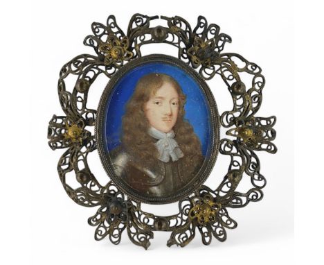 Attributed to Samuel Cooper (1609-1672), a 17thC oval portrait miniature of a gentleman, c1650, with long curling hair, weari