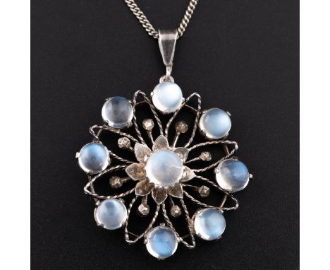 A 1930s unmarked white metal Tudor rose shaped moonstone pendant, with white metal wirework frame with nine moonstones, with 