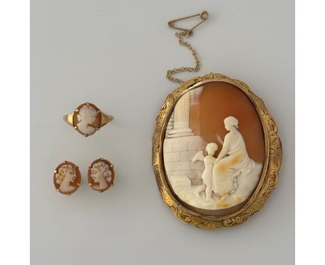 A late 19thC cameo shell brooch, carved with a lady seated in front of a building, with a putto standing next to her, set int