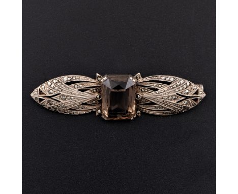 An Art Deco German white metal marcasite and smoky quartz brooch, c.1925, with openwork bow-shape set with marcasites and cen