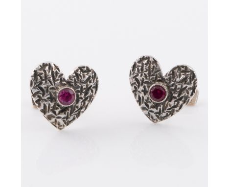 A pair of sterling silver heart-shaped cuff links with ruby centres, with London hallmarks for 1973, with original box, 2cm w