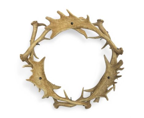 A stag's antler roundel, made from six mature stag's antlers bolted together, approximately 68cm outer widest diameter.FOOTNO
