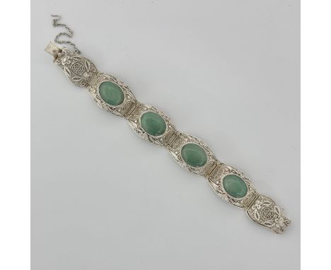 A 20thC Chinese export white metal bracelet, with inset green jade oval cabochons, and delicate and intricate filigree wirewo