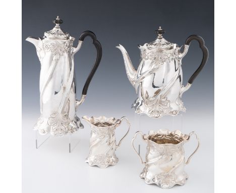 An Art Nouveau four piece sterling silver tea set by Charles Nixon, Sheffield 1901, hot water jug height is 28cm to top of fi