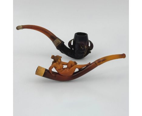 A late 19thC erotic themed Meerschaum pipe, carved as a naked lithe lady reclining on top of the curved pipe, with hair tied 
