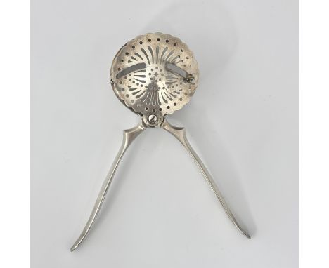 A French Christofle silver plated lemon squeezer, the scissor arms closing to squeeze the lemon, the pips being caught in a s