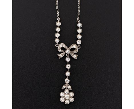 A white metal and paste necklace, with drop pendant with a floral design suspended from a bow unmarked, total chain length 44