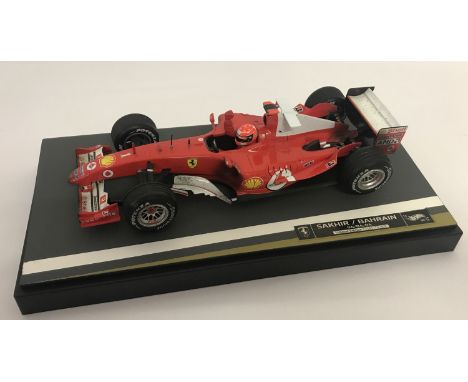 A limited edition Michael Schumacher 2004 Sakhir/Bahrain F1 Ferrari racing car by Hot Wheels. On a display plinth, Number 035