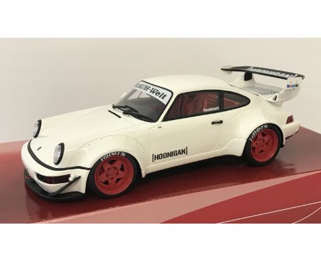 A 1:18 scale diecast model of a GT Spirit RWB 964 Hoonigan. In white and black with red interior and wheels. Rauh-Welt to fro