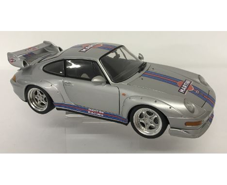 An unboxed Martini Racing Porsche 911 GT series by UT Models. Silver with Martini Racing decals. From a private collection.