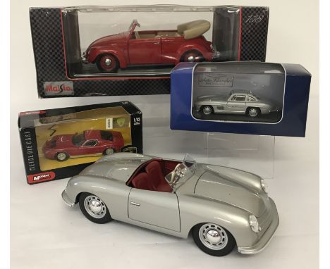 3 boxed and 1 unboxed diecast collectors cars. A VW 1951 Cabriolet 1:18 scale by maisto, a Lamborghini 1:43 scale by Mondo Mo