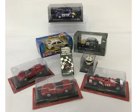 A collection of diecast model rally, racing &amp; sports cars together with 2 racing helmet key chains and a Uwe Alzen 1996 m