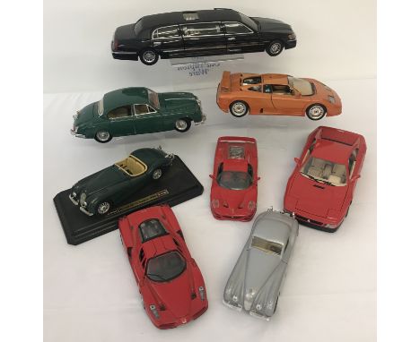 A box containing 8 larger scale diecast vehicles to include Maisto, Burago and Sun Star.  