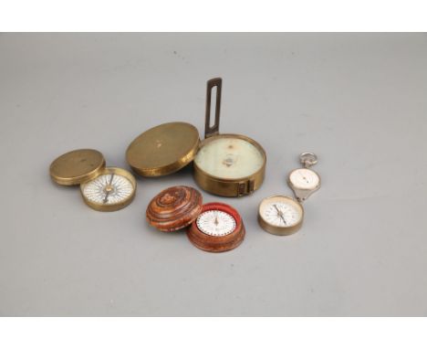 A Collection of Four Compasses, including an early brass cased compass with a paper dial and steel needle, an early compass i