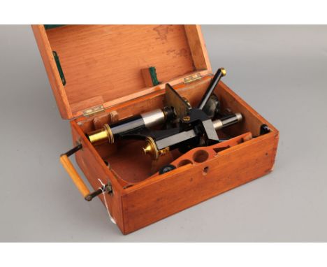 A Swift Microscope,English, c.1900, signed 'Swift &amp; Son, London' finished in black enamel and lacquered brass with two ob
