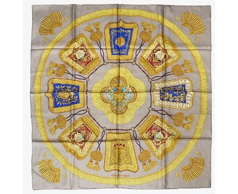 An Hermès 'Poste Et Cavalerie' silk scarf designed by Joachim Metz in 1986 features bright colours contrasting with the taupe