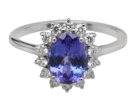 A tanzanite and diamond platinum cluster ringthe central stone surrounded by fourteen diamonds, on a platinum ring bandring s