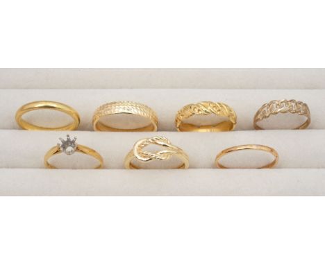 A group of 18ct and 9ct ringswith a 18ct hallmarked plain band ring, a fancy 18ct hallmarked twist ring and a 18ct hallmarked