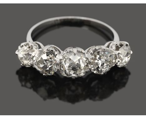 A diamond five stone ringwith slightly graduating old cut diamonds, claw set top and bottom to a fancy galleried mount with a