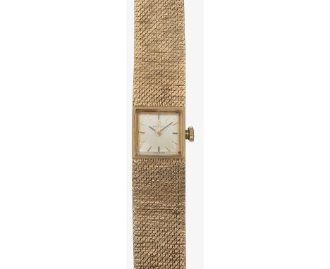 A 9ct gold lady's Omega manual wind bracelet wrist watch the champagne coloured square dial with baton numerals, bark effect 