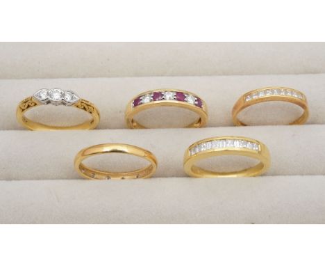 A collection of 18ct gold diamond ringsfeaturing a seven stone ruby and diamond eternity ring, 0.20ct stamp to inside, a elev