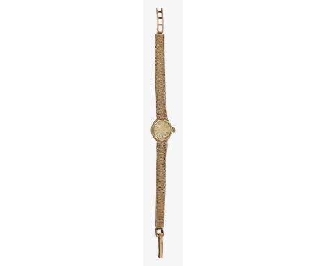 A 9ct gold manual wind rotary lady's wristwatchthe circular dial with raised baton numerals, bark effect strap, marked on the