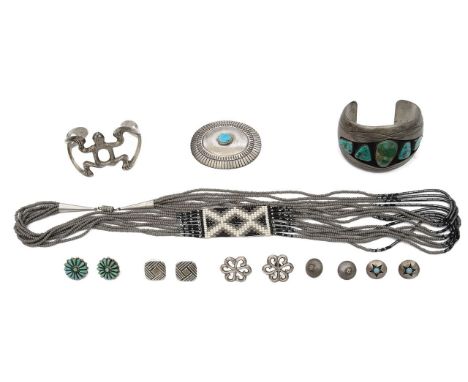 A collection of Native American Navajo silver jewelleryto include a sand cast open frog cuff bracelet stamped F. L. Begay, a 