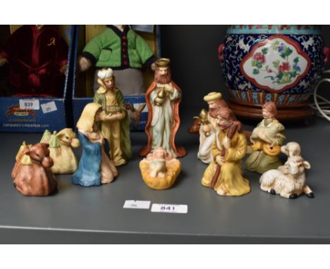 A vintage eleven piece ceramic nativity set in original box with a few sympathetic additions.