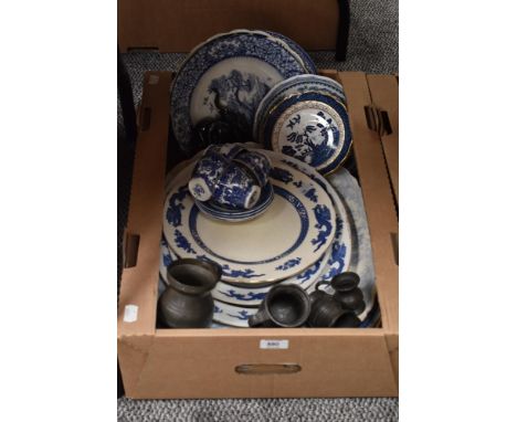 A selection of blue and white ware including platters and plates, four vintage pewter tankards and two wooden elephant studie