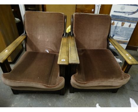 A Pair Of Early 20th Century Oak Framed Ercol Easy Chairs
