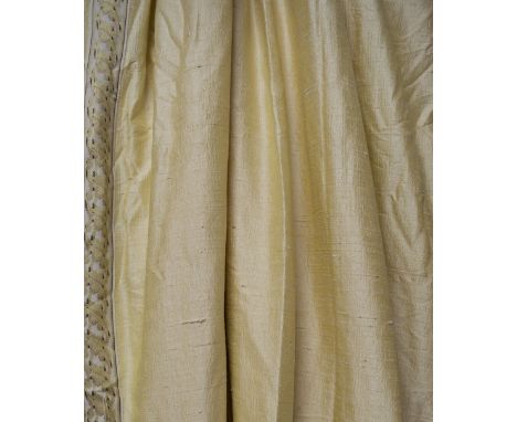 CURTAINS, a pair, light gold silk with an applied border, lined and interlined, 179cm gathered by 270cm drop. (2) (with fault