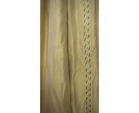 CURTAINS, a pair, gold silk with a decorative border with circle detail, lined and interlined, 120cm gathered by 260cm drop. 