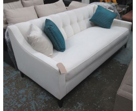 SOFA, two seater, in ivory fabric button back on ebonised square supports plus four scatter cushions, 210cm L.