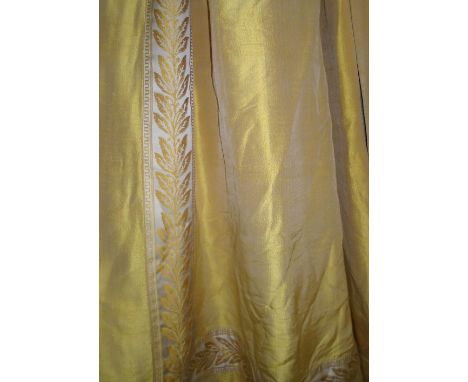 CURTAINS, a pair, gold silk with a decorative foliate border, lined and interlined, 223cm gathered by 270cm drop. (2) (with f