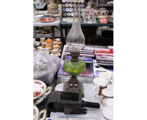 A VINTAGE OIL LAMP WITH METAL BASE, GREEN GLASS RESEVOIR AND CLEAR CHIMNEY PLUS A COACHING LAMP