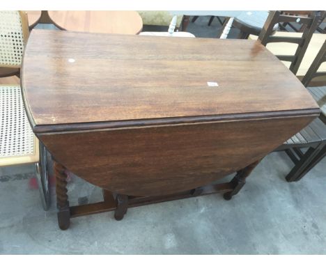 AN EARLY 20TH CENTURY OVAL OAK GATE LEG DINING TABLE, 58.5" X 41" ON BARLEY TWIST LEGS