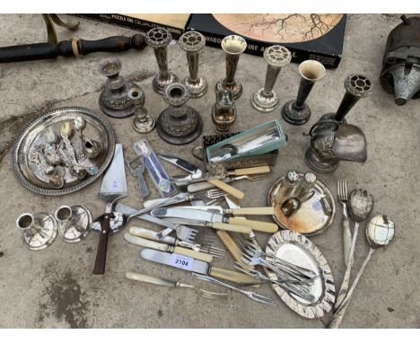 A LARGE ASSORTMENT OF SILVER PLATED ITEMS TO INCLUDE BUD VASES, FLATWARE AND CANDLE HOLDERS ETC