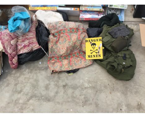 AN ASSORTMENT OF MILITARY STYLE CLOTHING AND A SIGN AND CURTAINS