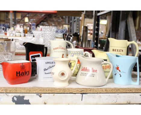 AN ASSPORTMENT OF CERAMIC JUGS TO INCLUDE AINELY, THE FAMOUS GOOSE, HAIG ETC