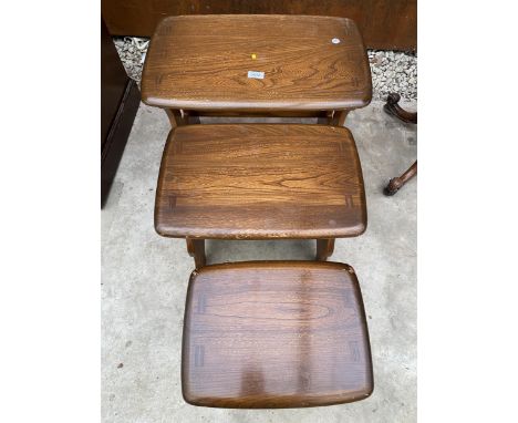 A BLONDE ERCOL NEST OF THREE ELM TABLES