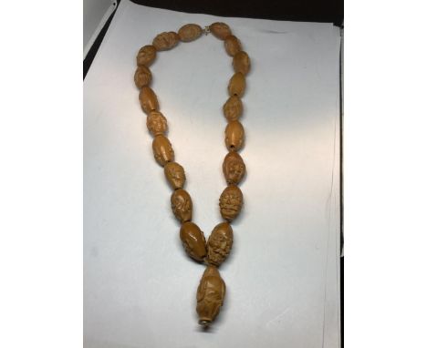 A JAPANESE KOKAE NUT CARVED HEADS NECKLACE DEPICTING TWENTY BUDDHIST SAINTS THOUGHT TO BE EARLY 20TH CENTURY