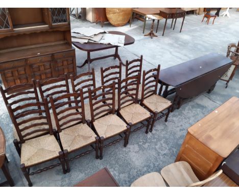 AN OVAL OAK GEORGIAN STYLE GATE LEG  WAKES TABLE, 90" X 62" OPENED AND TEN LADDER BACK RUSH SEATED DINING CHAIRS