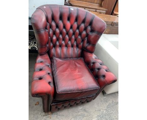 A SUPER SAGLESS OXBLOOD WINGED BUTTON BACK RECLINER CHAIR