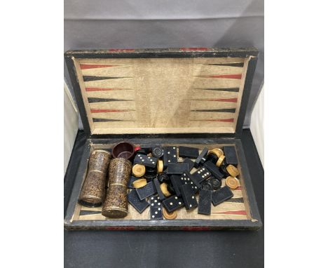 A VINTAGE CHESS, DRAUGHTS, BACKGAMMON BOX BOARD WITH A QUANTITY OF VARIOUS COUNTERS, SHAKERS, DICE ETC