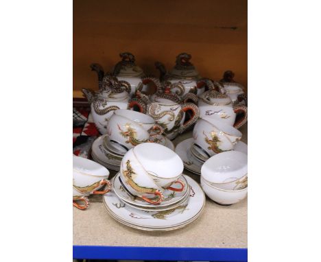 AN ORIENTAL TEASET WITH DRAGON DESIGN AND GEISHA GIRL TO THE BOTTOM OF THE CUPS, INCLUDING TEAPOTS, SUGAR BOWLS, CUPS, SAUCER