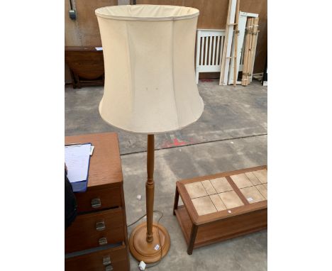 A SATINWOOD STANDARD LAMP WITH SHADE