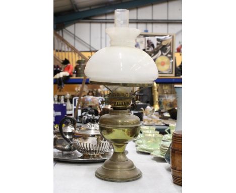 A VINTAGE BRASS OIL LAMP WITH AN OPAQUE SHADE AND CHIMNEY