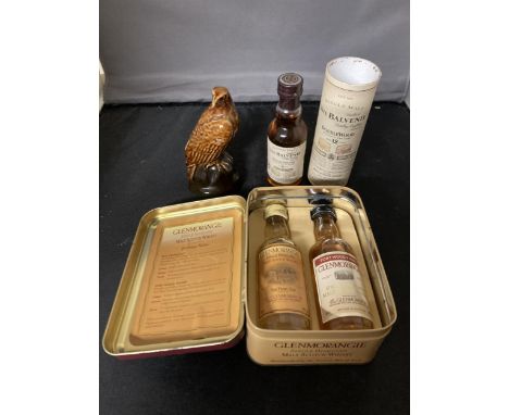 THREE MINATURE WHISKIES TO INCLUDE A TIN WITH TWO GLENMORANGIE, THE BALVENIE SINGLE MALT AND A BESWICK GOLDEN EAGLE MODELLED 