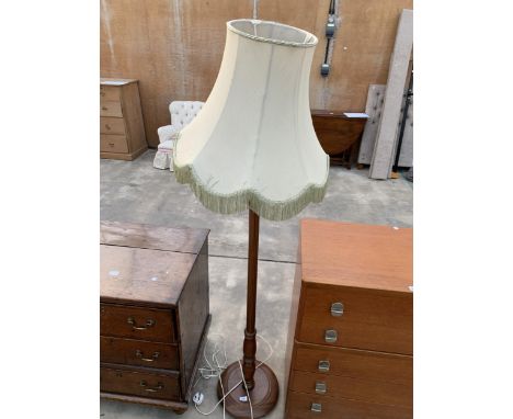 A BEECH STANDARD LAMP WITH SHADE